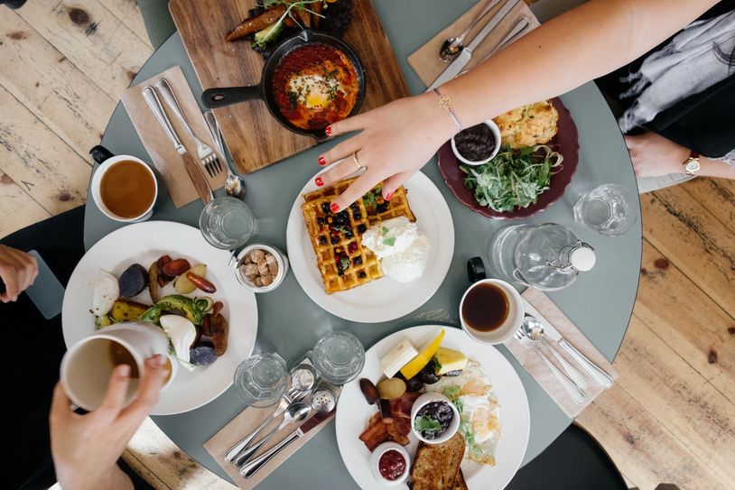 Overhead view of a breakfast with waffles and coffee.