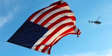 American flag and a helicopter above 