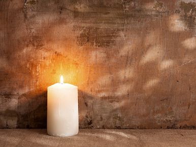 A lit candle burning near a wall. Property Clearing, Energy Clearing Nova Scotia  near Cole Harbour