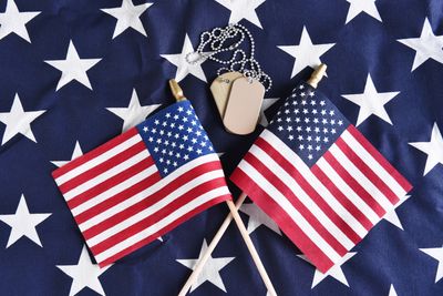 Patriotic image displaying flags and military name tags.