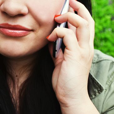 A woman talking to a phone