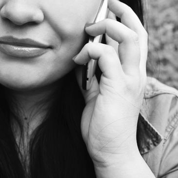 A woman with medium length hair talking on a cell phone