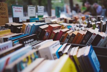 Books arranged closely on a market stall.