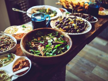 Table filled with various dishes and salads.