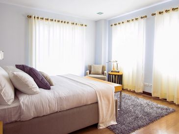 A bedroom with beige curtains