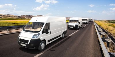 White vans moving goods to destination