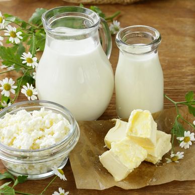 Fresh dairy products including milk, butter, and cottage cheese.
