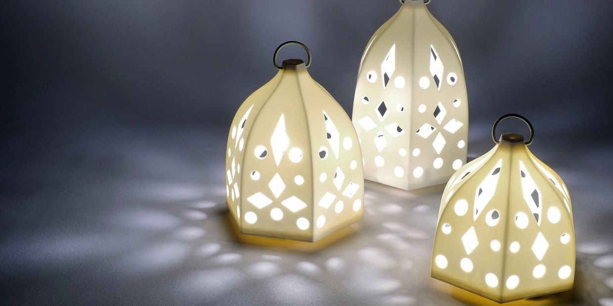 three white lanterns on surface emanating light