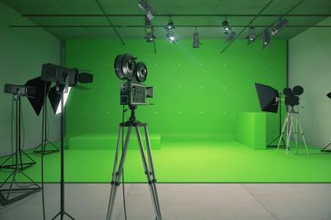 A professional film studio with green screen and cameras set up.