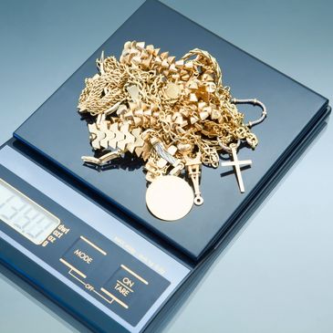 gold chains being weighed on a scale