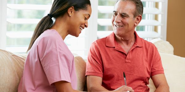 Photo of two people talking on a couch