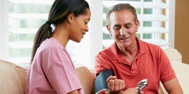 Stock photo of a nurse taking the blood pressure of a male patient