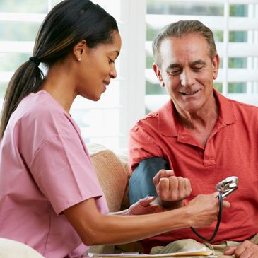 female nurse taking man's blood pressure in his home
