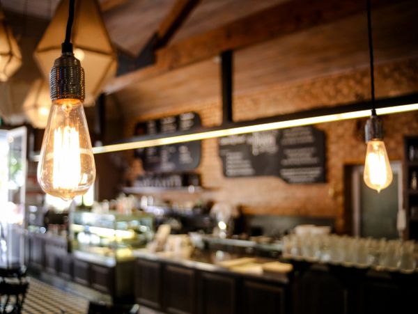 Vintage bulbs glowing in a cozy coffee shop.