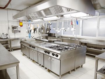 Clean, modern commercial kitchen with stainless steel appliances.