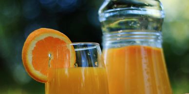 Fresh orange juice served in a glass with an orange slice.