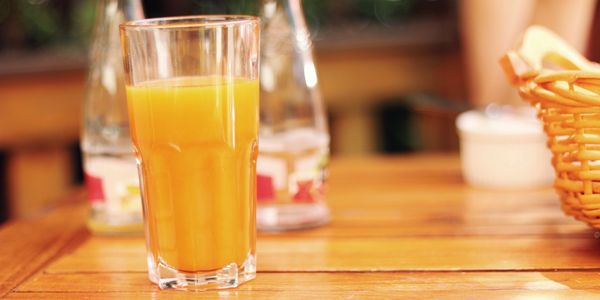 Yellow Juice glass on table 