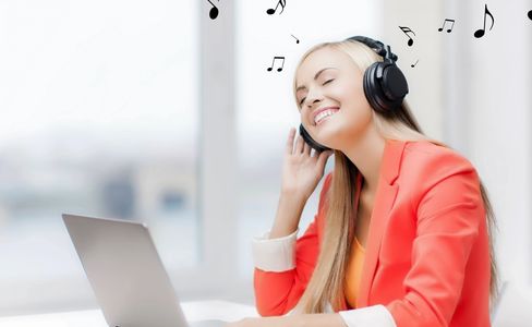 Lady in red shirt on laptop doing an online music lesson.