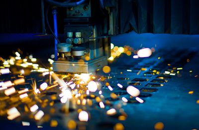 laser cutting of metal sheet with sparks flying 