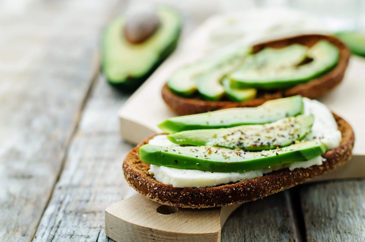 Close-up of a healthy avocado toast on whole grain bread with cottage cheese and seasoning—ideal for  clean eating, healthy fats, and metabolism-boosting meals.