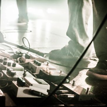 close up of a stage with soundboards and feet shown