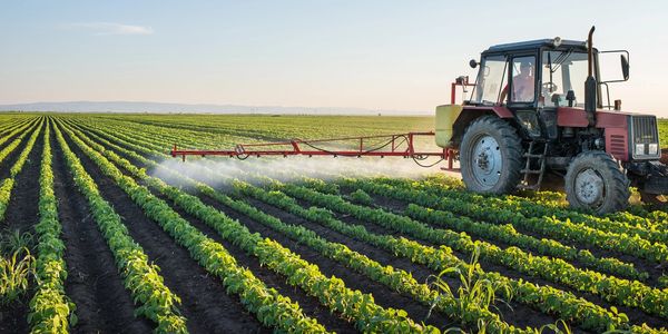 Tractor spraying agriculture field