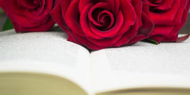 Roses sit atop a bible, representing when someone has passed. 