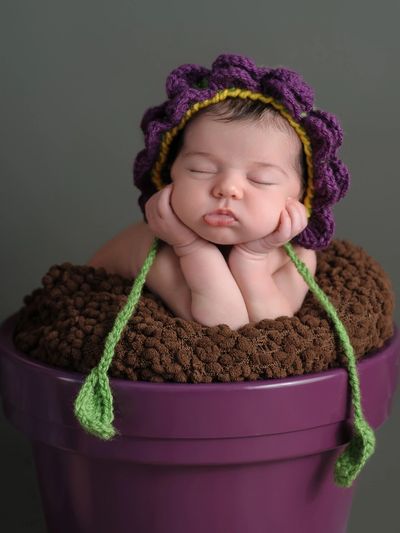 baby in a flower costume sleeping in a flowerport