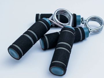 Foam-covered hand grip strengtheners on a white background.