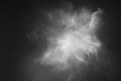 White powder explosion on black background.