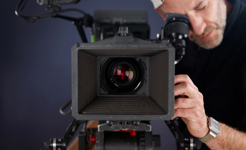 Man operating a professional video camera.