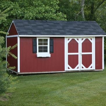 Red wooden garden shed with white trim and black shutters.