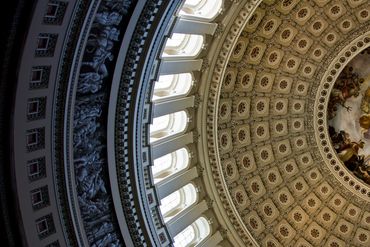 Interior dome of a historic building with ornate decorations.