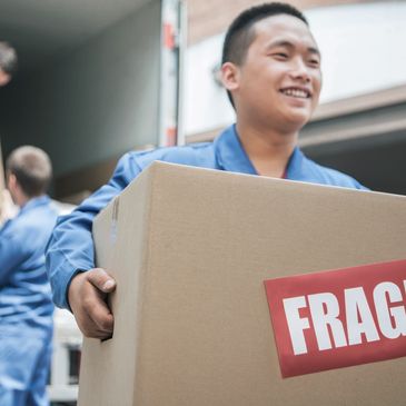 A person holding fragile carton box