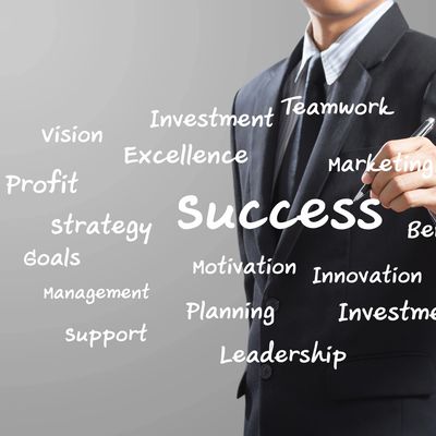 A man writing on the wall with words about success.