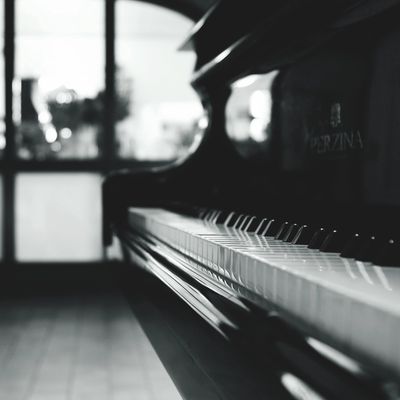Close-up of a piano keyboard in black and white.