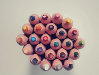 Top view of colorful pencil tips arranged in a circle.