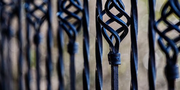 Close-up of a decorative black metal fence.