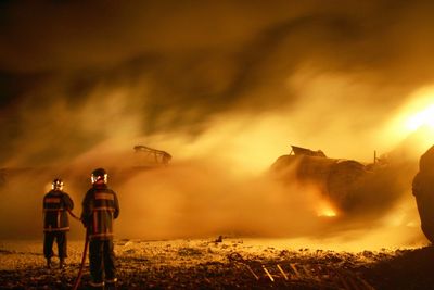 Wildland firefighters standing in front of an urban fire