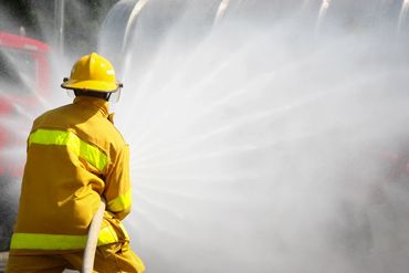 Fire person spraying water