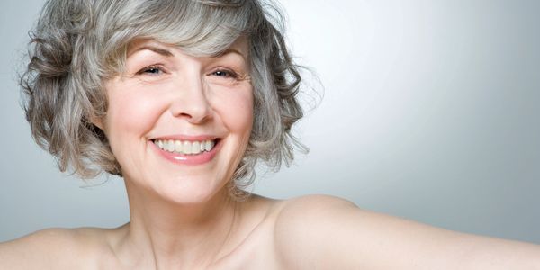 Middle aged woman getting hair done.