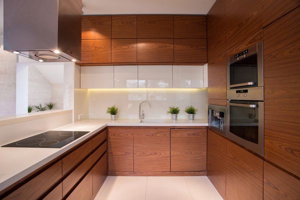 Modern kitchen with wooden cabinets and built-in appliances.