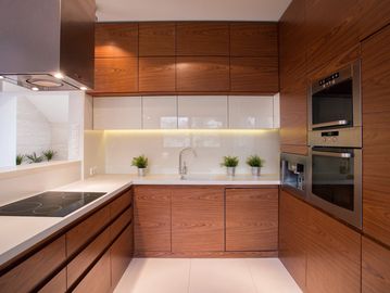 Modern kitchen with wooden cabinets and built-in appliances.