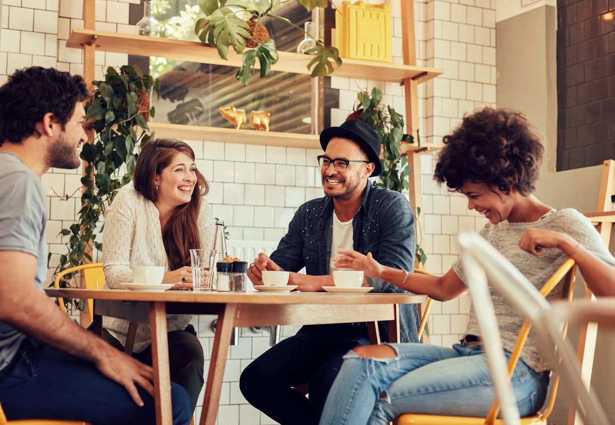 Group of friends happily chatting in a cafe.