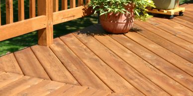 Beautiful stained deck, rails, and some Potted plants
