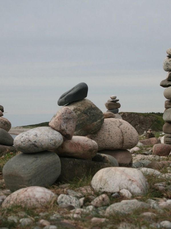 A headland with stones stacked into 5 different "figures" demonstrate solid foundations  and growth.