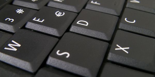Black computer keyboard with some letters showing