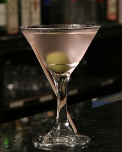 chilled martini in a classic martini glass garnished with a green olive