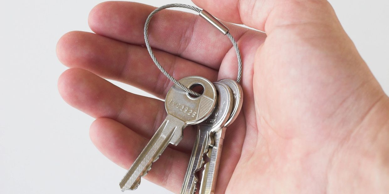 Hand holding a ring of metal keys