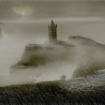 Foggy tower on a rocky hill.